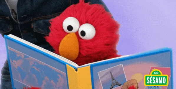 Gif do personagem Elmo, da Vila Sésamo, feliz lendo um livro.